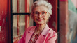 © katildam - A pretty and stylish elderly woman in a pink jacket and smiles at the camera