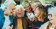 © Davide Angelini - Happy group of senior people laughing together indoors - Delightful aged friends having fun
