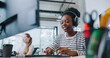 © ihorvsn - Camera view of diverse women sitting in front of computer displays. Worker on right side and wearing headset for remote consultation with clients. Working in call center. Customer support.