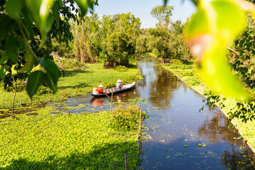 Beautiful tropical river in Asia with a boat among green nature