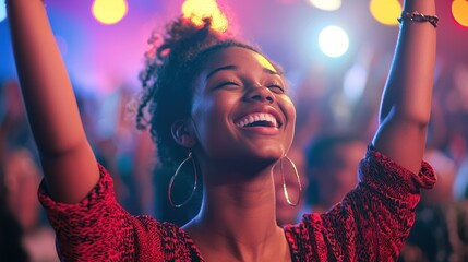 Wall Mural - A young woman with her hands up, smiling broadly at a concert.