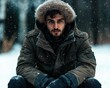 © Vlad - Outerwear: Man Sitting Outdoors, Gazing at Camera on Snowy Winter Day