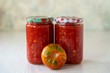 Homemade tomato sauce for the winter on white table