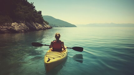 Sea Kayak Adventure: Woman Paddling along the Coastline for Leisure and Sport