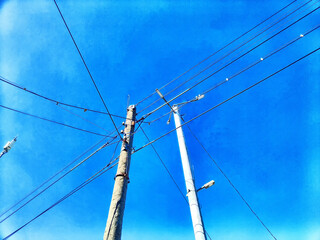 Old pole with wires against the sky. Electric transmission line. Eco-friendly energy