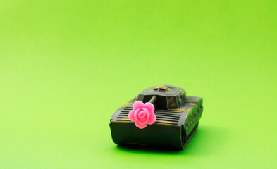 End of a conflict symbolized by a war tank and a pink rose