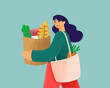 © Connect Images - Smiling young woman carrying groceries in a reusable bag with a loaf of bread sticking out.