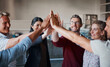 © peopleimages.com - Employees, high five and hands in huddle for success, teamwork and diversity in company mission. Business people, united and circle for motivation with goals, solidarity and collaboration achievement