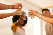 © wavebreak3 - Toasting with drinks, diverse friends celebrating together in casual setting