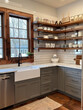 © VERTEX SPACE - A modern farmhouse kitchen featuring shaker style cabinets, open shelving, and farmhouse sink. warm wood accents and natural light create cozy atmosphere