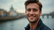 © vstudio - young smiling handsome man smiling portait photo river bridge cityscape blurred background