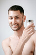 © Elina Leonova - Man using cream. Health care concept. SPA