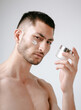 © Elina Leonova - Man using cream. Health care concept. SPA