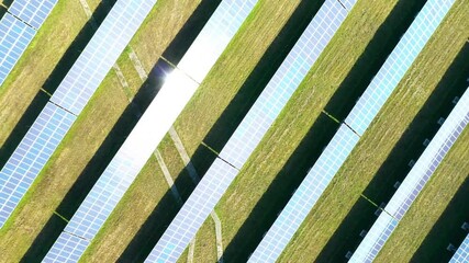 Wall Mural - Camera flight over a solar power plant. Industrial background on renewable resources theme. Industry of power and fuel generation in European Union.