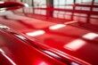 © Introvertia - Close-up of shiny red car paint with glossy finish
