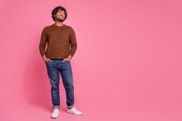 Photo of nice cheerful positive man wear stylish brown clothes look empty space isolated on pink color background