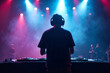 © Flash - D.J. man standing in concert hall with smoke and colorful light enjoy music festival , generative AI