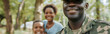 © Mahemud - Happy African American soldier in military uniform looking at the camera with family in the park