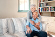 © Malambo/peopleimages.com - Hug, portrait and senior couple on sofa for connection, bonding and relax together at home. Happy, love and elderly man and woman in retirement embracing, marriage and resting in living room at house