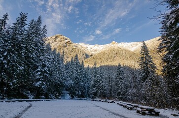 Winter. International Mountain Day. Global Climbing Day. Winter solstice Asphalt road and snow mountain nature background.