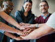 © AK Coop/peopleimages.com - Employees, hands and pile in huddle for cooperation, teamwork and diversity in company mission. Business people, stack and circle for motivation with goals, solidarity and workforce collaboration
