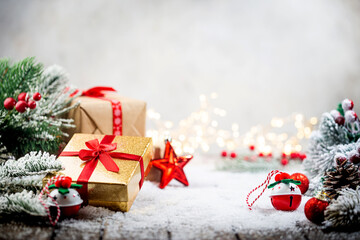 Wall Mural - christmas red decorations on snow with gift boxes, fir tree branches and christmas lights. winter de