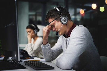 Poster - Man, call center and headache at night in office with stress, exhausted and pain by computer for tech support. Person, migraine and profile with voip, headphones and burnout at customer service job