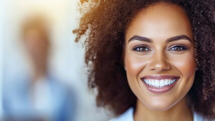 Wall Mural - A woman with curly hair is smiling and has her teeth showing