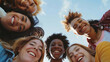 © Mahemud - Low angle view of a happy group of multiracial friends looking at the camera, enjoying outdoors. Multiethnic cheerful young people
