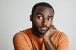 © robertuzhbt89 - Thoughtful Young Man in Orange Shirt