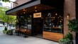 © Sasikharn - A brick building with a wooden front door and a sign that says 'Open'. The building has a patio with several chairs and potted plants