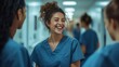 © Bijac - candid moment of nurses laughing in hospital corridor warm lighting genuine camaraderie modern medical setting