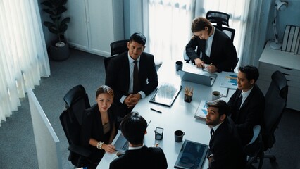 Top view businesspeople placed tablet at table and planning strategy while diverse team discuss about financial plan. Group of diverse team brainstorm marketing idea at meeting table. Directorate.