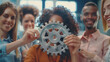 © Mahemud - Office worker holding a cogwheel, symbolizing unity and teamwork in a corporate setting. Represents the visionary system and mechanism for business success
