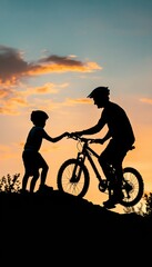 Silhouette of a father helping his son to get on his mountain bike.