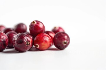 Wall Mural - A pile of fresh cranberries on a white surface, ideal for food styling and photography