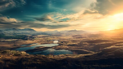 Wall Mural - Golden hour casts a warm glow over a landscape with rolling hills, a valley, and a pair of lakes.