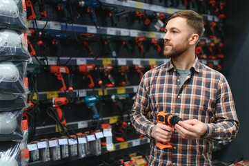 Man shopping for drill in hardware store