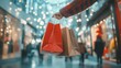 © Johannes - Hand holding packages shopping bags in shopping mall. Boxing Day winter sale. Empty copy space, panorama. Holiday indoor blurred bokeh background. transparent background