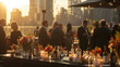 © netrun78 - A romantic outdoor roof top dining setting as the sun sets, with guests enjoying the ambiance of warm candlelight and city views. Birthday, corporate party celebration.