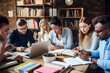 © Matilda - Multicultural Group of Engrossed Students Studying Together in a Library