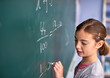 © FotoPush/peopleimages.com - Chalkboard, education and girl in maths class at school for child development, learning or study. Equation, solution and writing with student in classroom for academic knowledge or scholarship