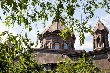 Wall Mural - green leaves and black tuff Cathedral in Gyumri