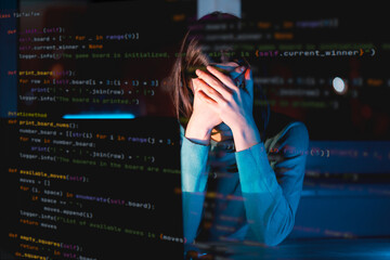 Girl works on a laptop at night, coding and creating project.