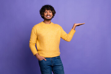 Canvas Print - Photo of funny cheerful nice man wear trendy yellow clothes presenting empty space isolated on violet color background