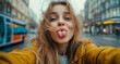 © Mangevigne - Fun and Playful Selfie of Young Woman Sticking Tongue Out