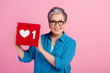 Canvas Print - Photo portrait of pretty retired female hold heart social media icon wear trendy blue outfit isolated on pink color background