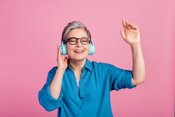 Sticker - Photo portrait of pretty retired female headphones enjoy music dance wear trendy blue outfit isolated on pink color background