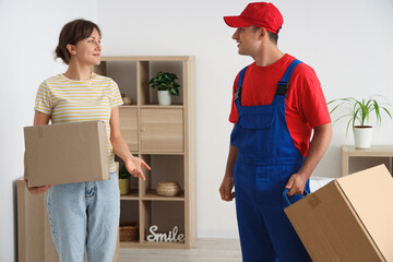 Wall Mural - Young woman receiving parcels from delivery man at home