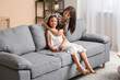 © Pixel-Shot - Beautiful young happy Asian mother and cute little daughter hugging at home